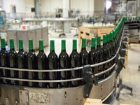Packaging machinery moving wine bottles